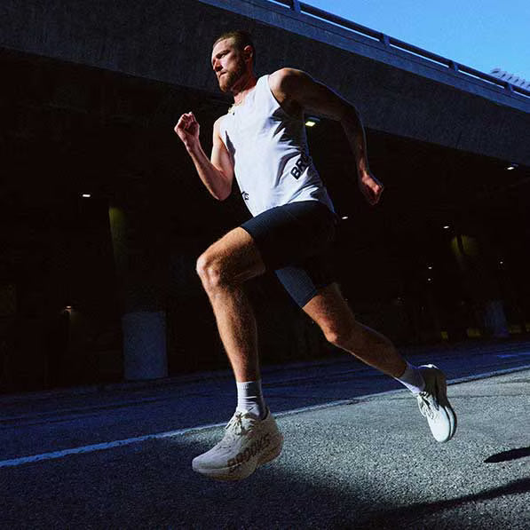 A man running outside wearing running apparel