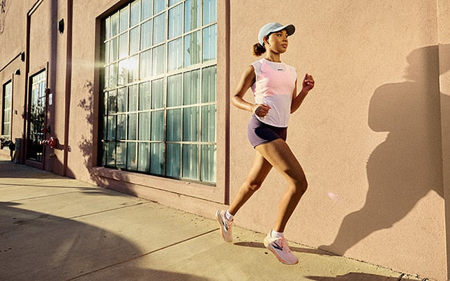 Woman running on the sidewalk in the city