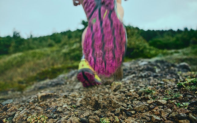 Close-up of a running shoe on a rocky trail