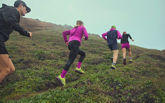 Group of people running on a trail